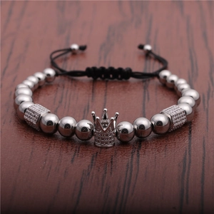 Fashionable crown bead bracelet with zircon accents on a brown leather surface