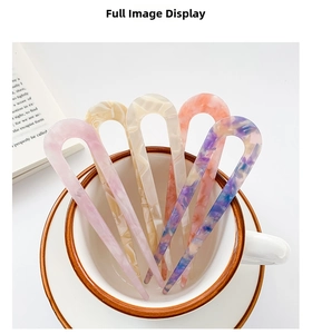 U-shaped hair pins in acetate fiber with marble patterns displayed in a coffee cup