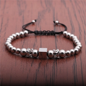 Adjustable braided bracelet with cubic beads and crown charms in silver-black metal finish
