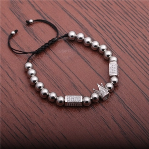 Silver beaded crown bracelet with micro-pave cubic zirconia on wooden background