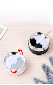 Close-up of windproof rotating lid design on black and white stainless steel ashtrays