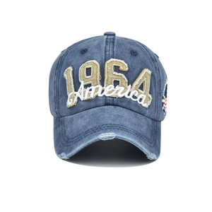 Detail of 1964 America embroidery and distressed ripped brim on vintage denim baseball cap