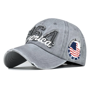 Macro detail of USA embroidery and distressed denim brim on a gray vintage baseball cap