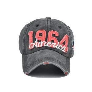 Macro view of distressed grey cotton baseball cap with 1964 America embroidery detail