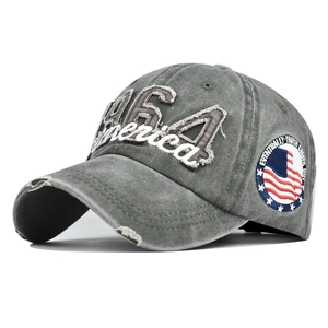 Detail of 1964 America embroidery and American flag patch on washed grey cotton cap