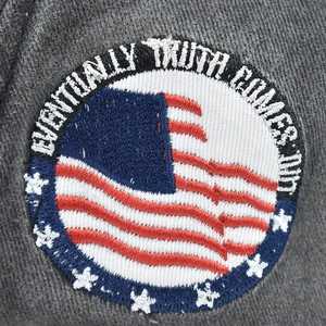 Macro shot of 1964 embroidery and star badge on gray cotton vintage baseball cap