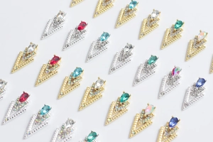 Macro view of 3D V-shaped alloy nail art jewels with colorful teardrop crystals
