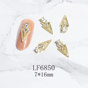 Detailed close-up of golden triangle nail art charm with rhinestones in 7x16mm size