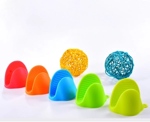 Detail view of five colorful heat-resistant silicone oven mitts for kitchen grip