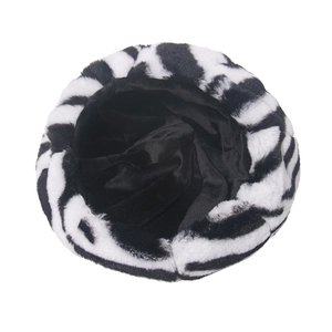 Macro detail of zebra print plush beret featuring thick faux fur texture and black lining