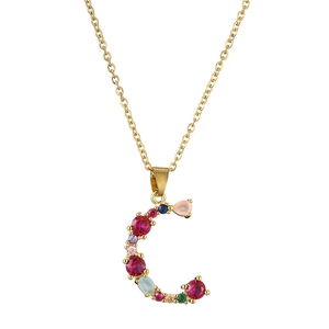 Detailed close-up of a golden C-shaped pendant with colorful inlaid gemstones
