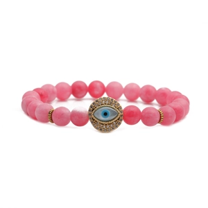 Pink matte agate bead bracelet featuring a gold-plated evil eye pendant with crystals