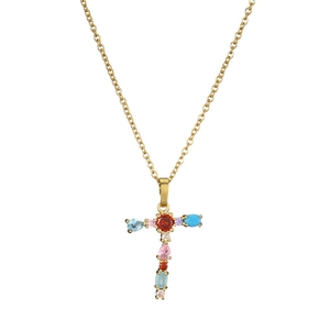 Macro detail of gold T-shaped cross pendant with colorful gemstones on O-chain necklace