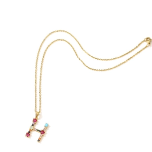 Detailed shot of golden H letter pendant featuring colorful multi-gemstone pavé setting