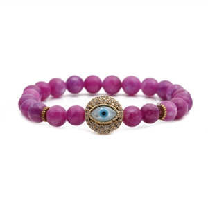 Purple agate beaded bracelet with golden accents and blue evil eye charm on white background
