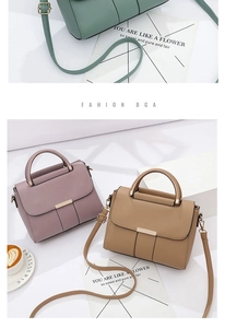 Detail of trendy PU leather handbag with metallic snap closure and adjustable strap