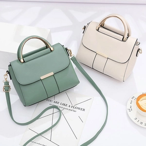 Structured tote bags in green and beige leather with gold handles and shoulder straps