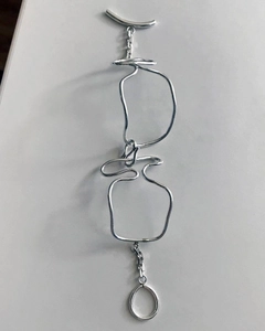 Detail of 925 sterling silver woven knot bracelet with abstract minimalist chain links