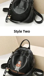 Detail of black PU mini backpacks with bear embroidery and cartoon doll charms
