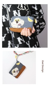Detail of handmade grey felt coin purse with owl embroidery and colorful braided strap