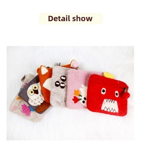 Detail of assorted handmade felt coin purses with cute animal characters and embroidery