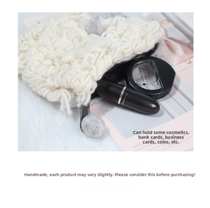 Detail of handmade wool felt mini pouch showing plush texture and small cosmetics storage