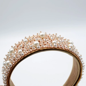 Close-up of luxury Baroque headband with white faux pearls and rose gold beads