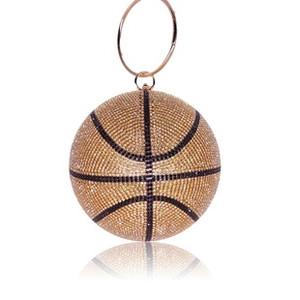 Detail of golden basketball-shaped evening bag featuring rhinestones and a metal handle