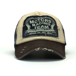 Close-up of distressed racing patch and vintage colorblock canvas on baseball cap