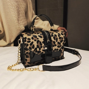 Chic leopard print crossbody bag with gold hardware and black patent leather trim