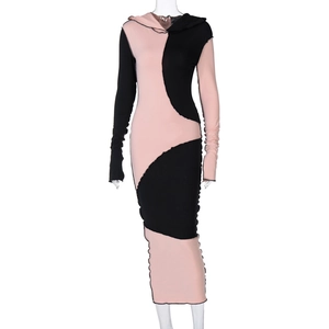 Detail view of ribbed knit fabric texture and irregular patchwork stitching on hooded dress