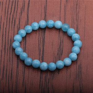 Macro shot of 8mm blue tiger eye beads on an elastic bracelet with polished finish