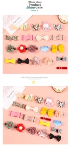 Detailed view of children's hair clips featuring colorful glitter bows and flower designs