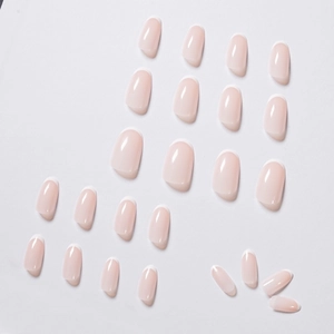 Glossy nude pink French press-on nails with white tips in a full set for daily manicure