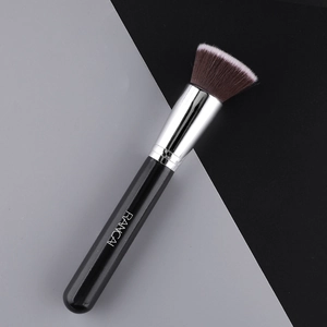Detail of flat top foundation brush with dense dual-tone bristles and silver metal ferrule