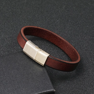 Close-up of brown leather bracelet with magnetic metal clasp on black jewelry box