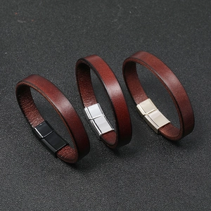 Detail of genuine brown leather bracelets with magnetic alloy buckles in black, silver and gold