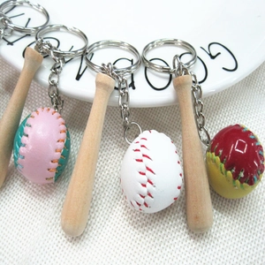 Detail of mini wooden baseball bat keychain with colorful stitched leather ball pendant