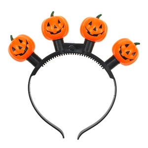 Detail view of Halloween pumpkin headband with four glowing LED lights and orange pumpkin faces