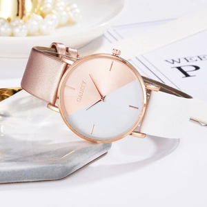 Elegant two-tone quartz watch for women displayed on a marble tray with pearl accents