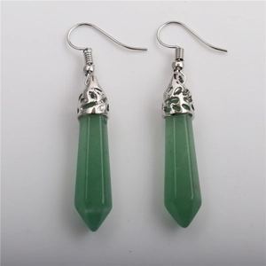 Detail of green hexagonal crystal drop earrings with silver ornate floral caps