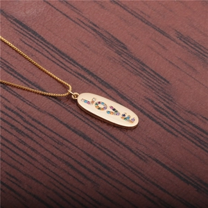 Golden necklace with micro-pave colorful zircon LOVE pendant on dark wooden background