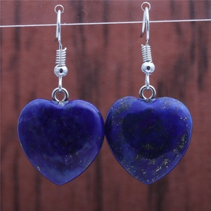 Detailed view of heart-shaped blue lapis lazuli earrings with silver hooks
