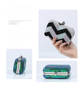 Detail of sparkly sequin clutch evening bags with metal spherical clasps and hard shell design