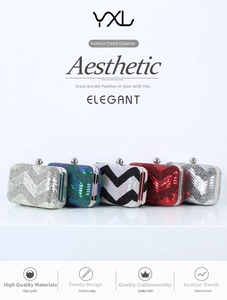 Detailed row of mini sequin clutch bags featuring chevron patterns and metallic ball clasps
