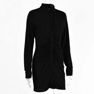 Detail of black long sleeve shirt dress with button-up front and ruching texture