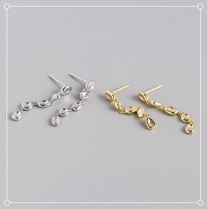 Close-up of polished S925 sterling silver irregular tassel earrings in gold and silver