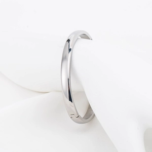 Minimalist 6mm polished silver steel bangle with side clasp on a white background