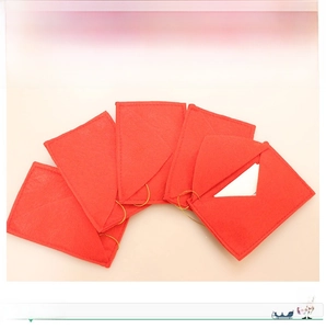Detail of red felt Christmas envelope ornaments with gold strings for tree decor
