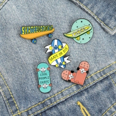 Detailed close-up of skateboarding enamel pins set pinned on a blue denim jacket pocket